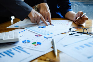 Business People Meeting to discuss and brainstorming the financial report paperwork in home office. Financial advisor teamwork and accounting concept.