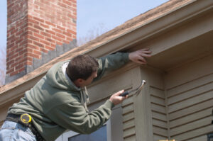 Man working on home ready to hammer a nail